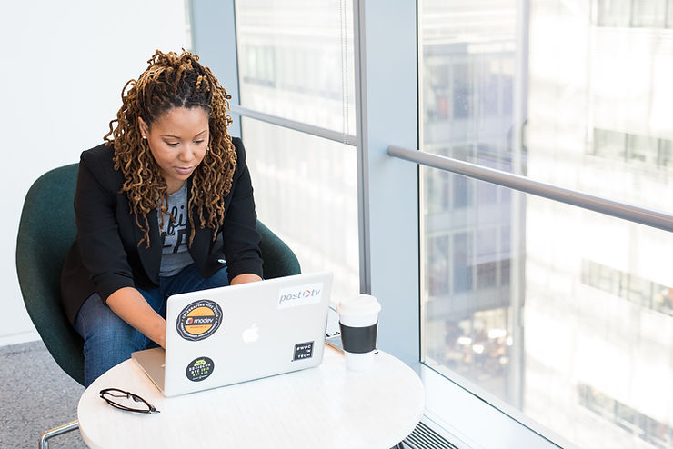 woman in office looking at laptop screen