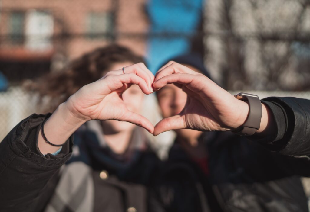 couple creating heart with their hands