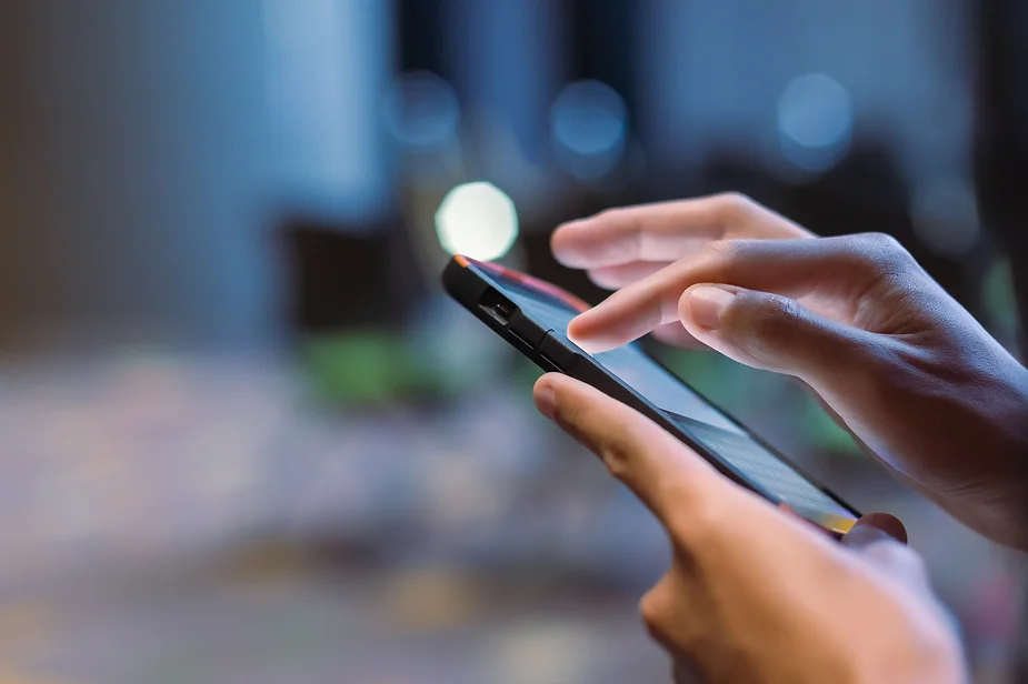 close up of person's hands pressing on a mobile screen