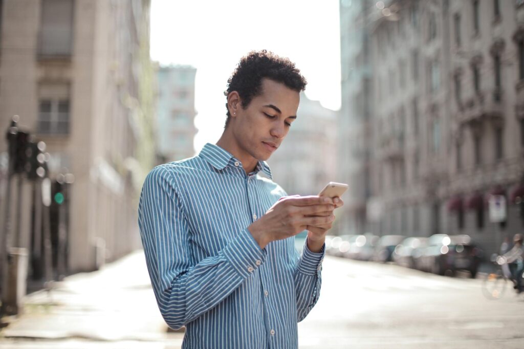 concentrated guy using smartphone to apply for short term loan
