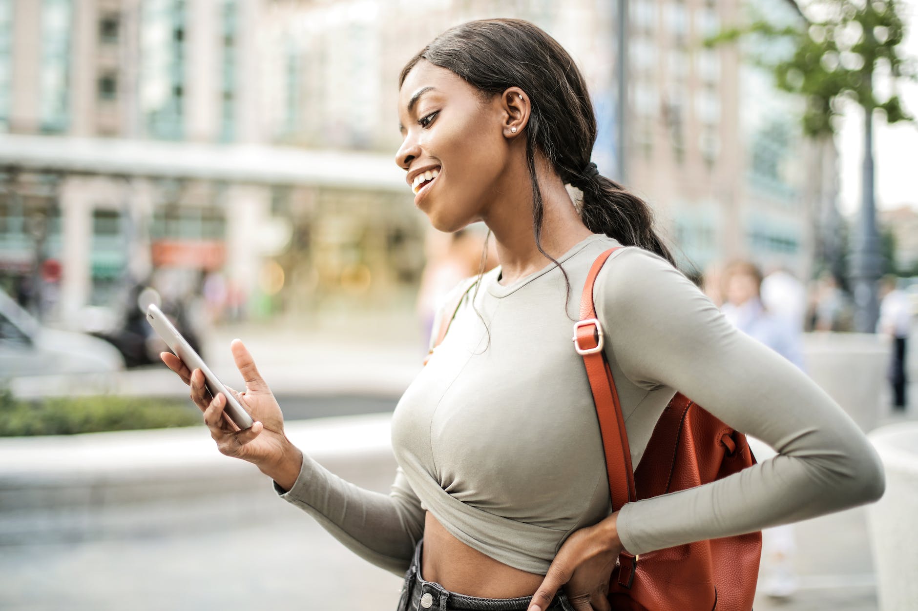 shallow focus photo of woman holding smartphone looking for a quick loan