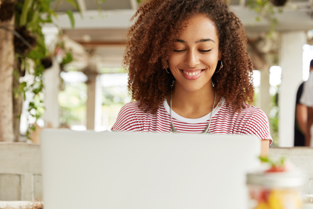 smiling women looking at laptop screen for understanding credit score