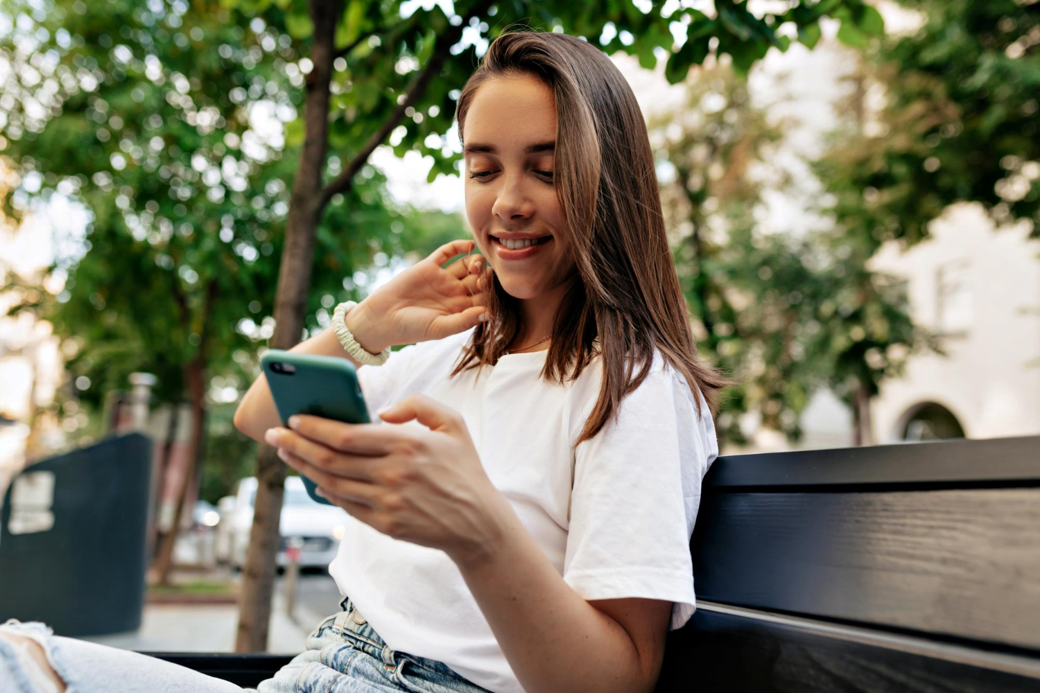 woman looking down at mobile phone to contact fasta loan