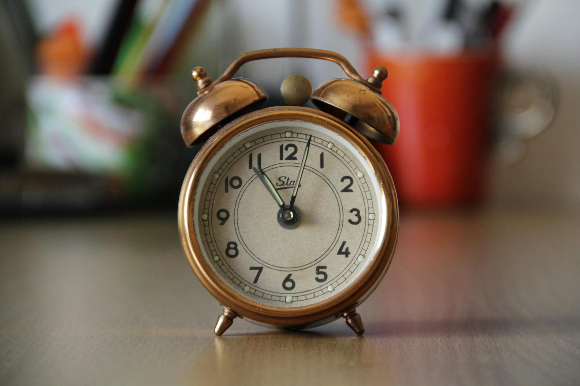 focus photography of brown double bell alarm clock