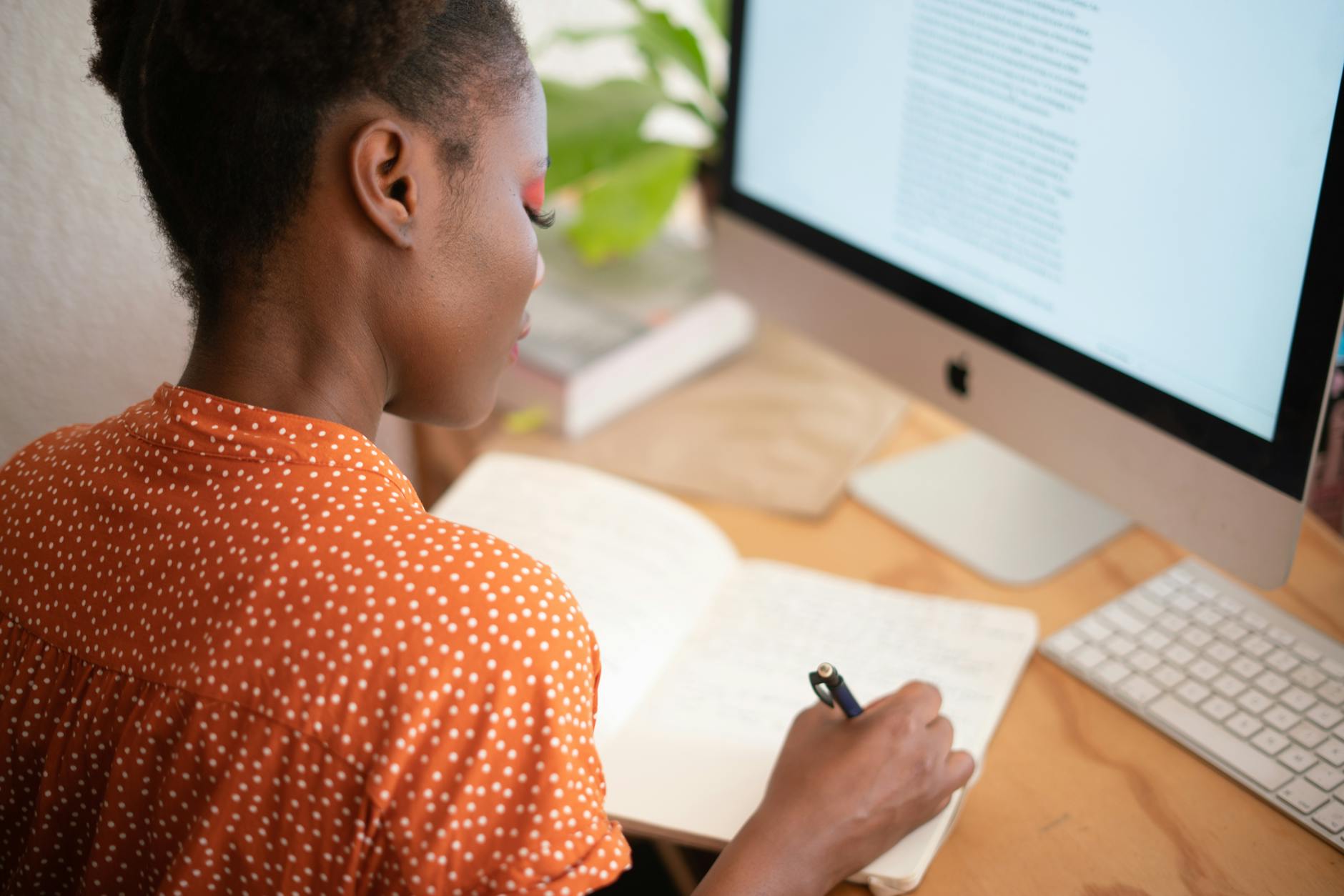 woman writing on her notebook for 3 tips on improving chances of a successful quick loan application